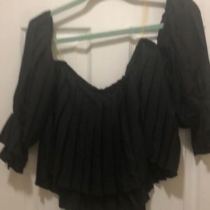 Woman’s black pleated blouse long sleeves